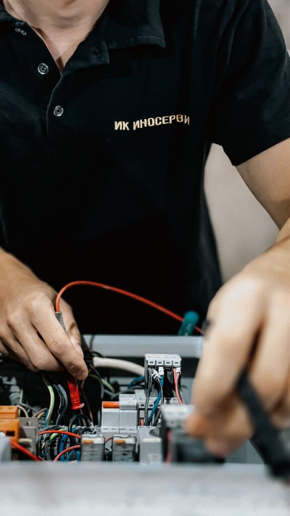 Electrical contractor working on wiring in low light